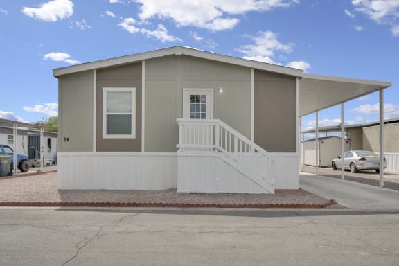a manufactured home with a porch and stairs
