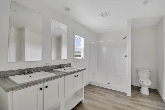 a bathroom with two sinks and a toilet