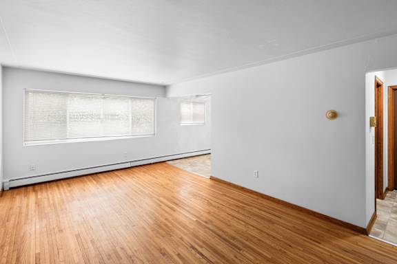 A room with wooden floors and white walls.
