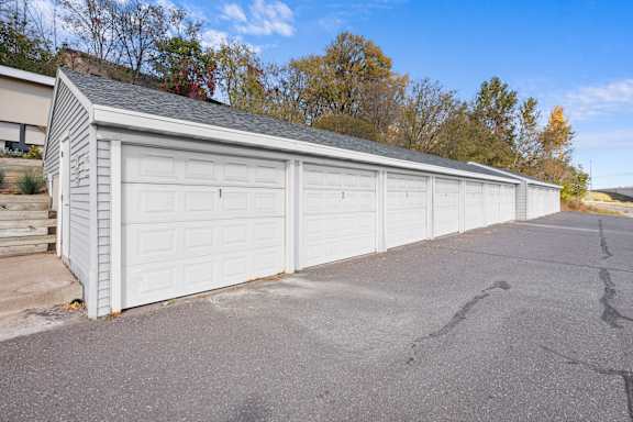 A two-car garage with a white exterior and a grey roof.