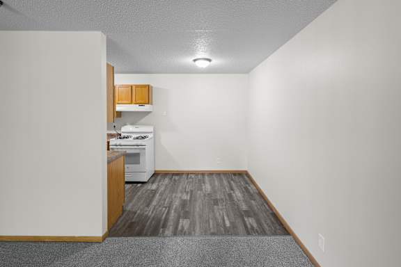 A kitchen area with a white fridge, microwave, and oven.