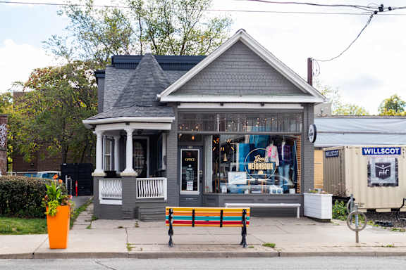a small building with a bench in front of it