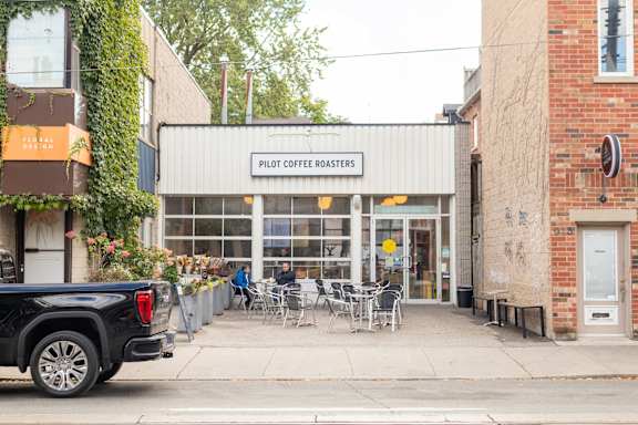 a truck parked in front of a restaurant on the street