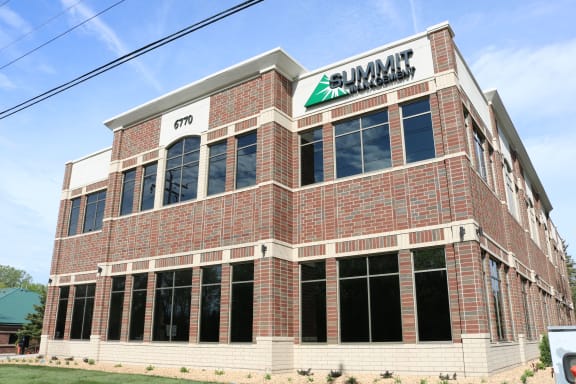 a brick building with a sign on top of it