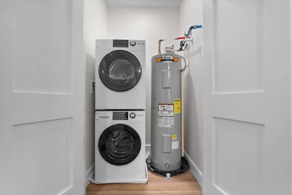 A washing machine and a water heater in a small room.