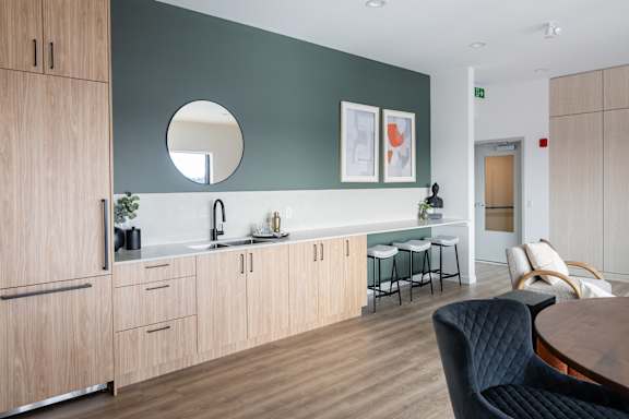 A modern kitchen with a wooden table and chairs.