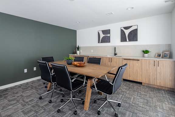 A conference room with a table and chairs.