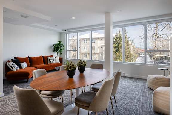 A modern living room with a large table and chairs.
