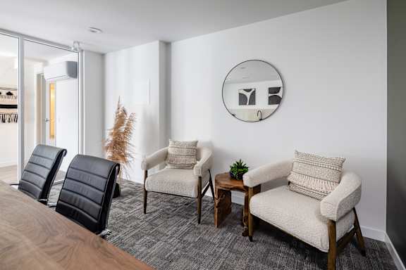 Three chairs are placed in a room with a mirror on the wall.