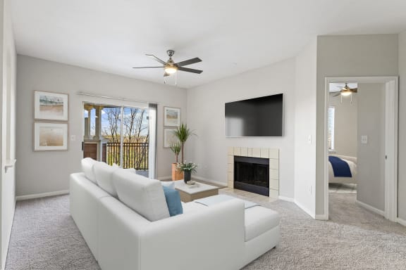a living room with a white couch and a ceiling fan at The Legends at Eagle Mountain Lake, Fort Worth, Texas