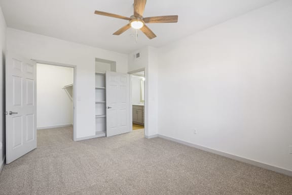 an empty bedroom with a ceiling fan and a closet at The Legends at Eagle Mountain Lake, Fort Worth, TX, 76179