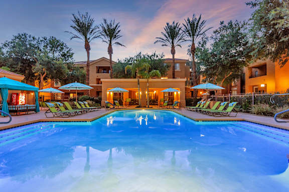 A swimming pool in a sunny outdoor setting.