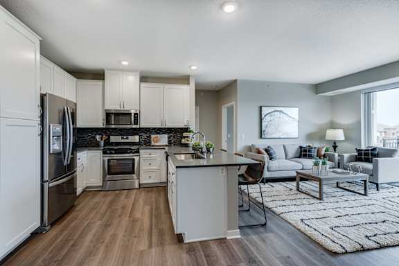 Spacious kitchen with quartz counter tops and spacious living area of 2 bedroom apartment for rent at Ascend at Woodbury best new apartments Woodbury MN 55129