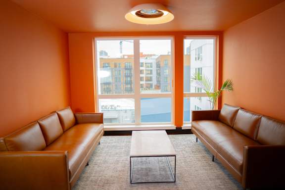 a living room with leather couches and a coffee table