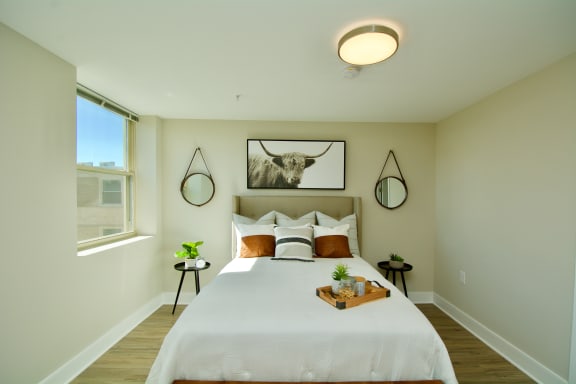 a bedroom with a large bed and a large window