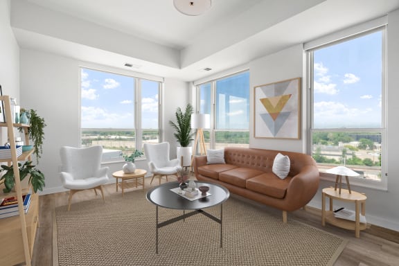 an open living room with a brown couch and a table