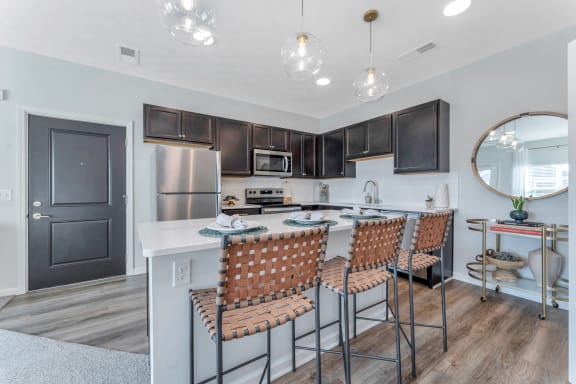 a kitchen and dining room with a table and chairs