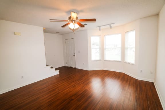 a living room and kitchen with a dining table