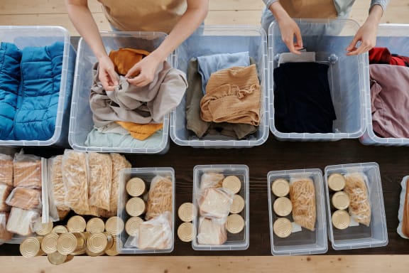 volunteers sorting food and items into containers