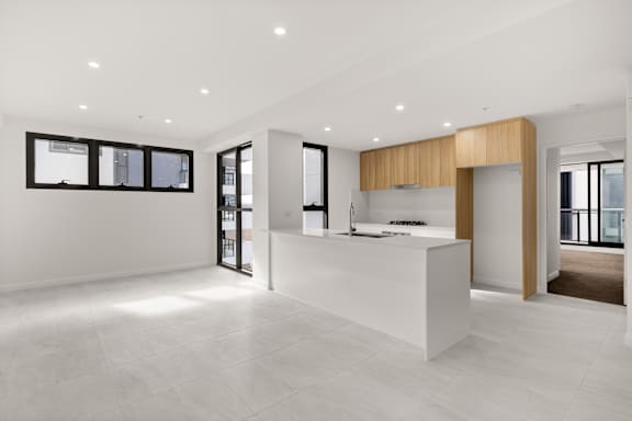 A modern kitchen with a white countertop and a large island.