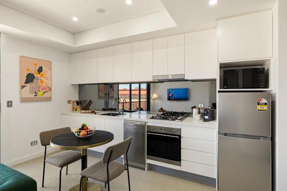 A modern kitchen with a table and chairs.