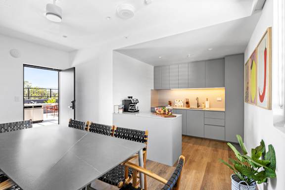A modern kitchen with a dining table and chairs.