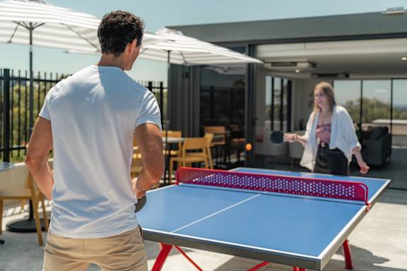 a man and a woman playing ping pong on a table
