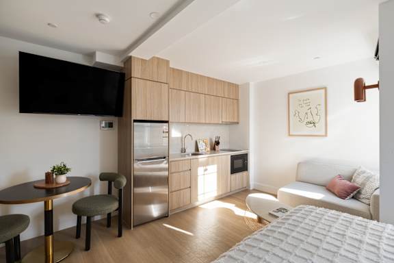 A modern kitchen with a dining table and chairs.