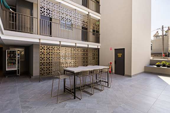 A table with chairs is set up outside a building.