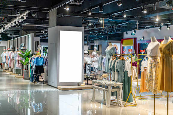 A clothing store with a variety of dresses on display.