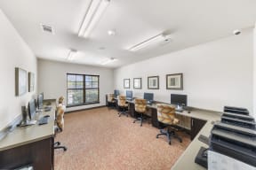 a conference room with desks and chairs and a piano