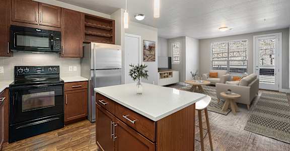 A modern kitchen with dark wood cabinets and a white island.