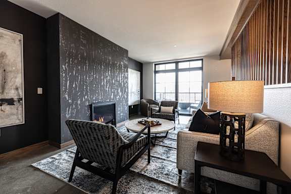 A living room with a fireplace and a chair.