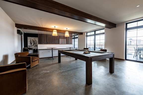 A modern dining room with a long table and chairs.