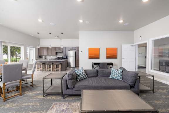 A modern living room with a grey couch and a wooden coffee table.