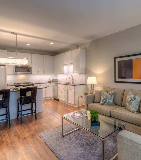 A modern kitchen with a dining table and a couch.