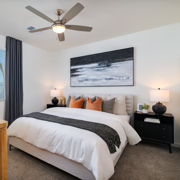 a bedroom with a large bed and a ceiling fan