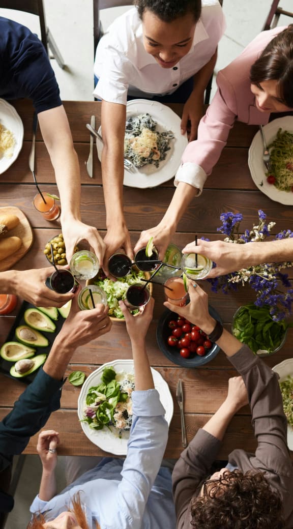 a group of people sitting around a table eating food