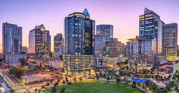 a view of a park and the city skyline at night