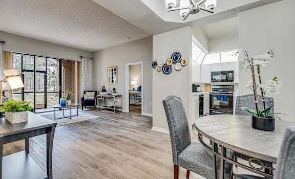 an open living room and dining room with a table and chairs