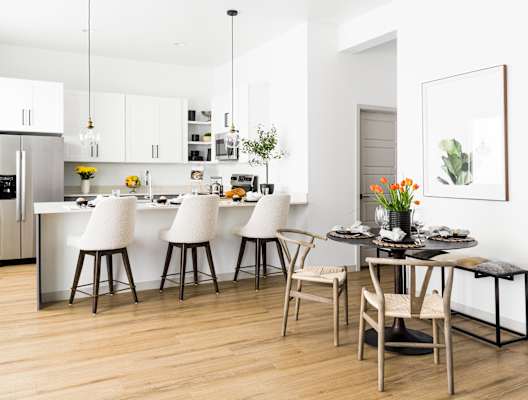 a kitchen and dining area with white cabinets and a table and chairs at Onyx at Westgate Apartments, Glendale, AZ, 85305