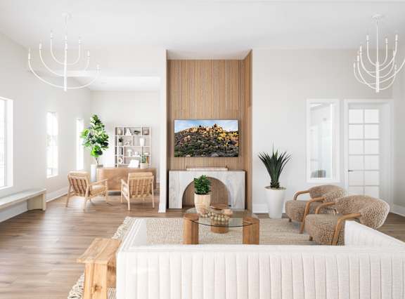 A modern living room with a large painting on the wall and a white sofa.