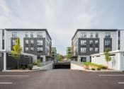 Thumbnail 6 of 8 - a group of new apartment buildings with a parking lot