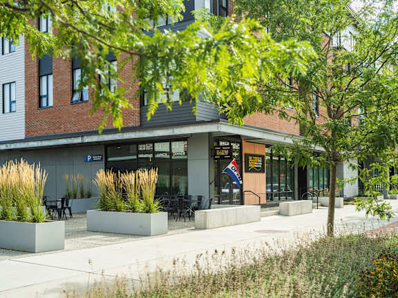 A building with a green lawn in front.