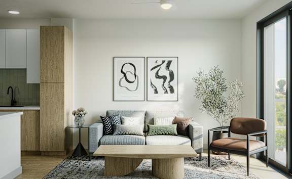 A modern living room with a grey sofa, a wooden coffee table, and two abstract art pieces on the wall.