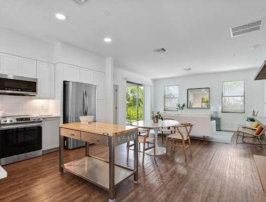 an open kitchen and dining room with a table and chairs at Odyssey, Fort Myers, FL, 33905
