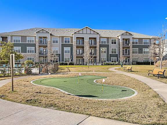 an exterior view of an apartment building with a mini golf course at North Creek, Hutto, 78634