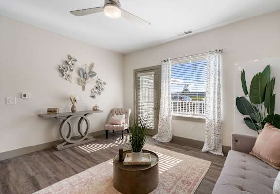 a living room with a couch and a chair and a window at 41 North Apartments, Fort Wayne