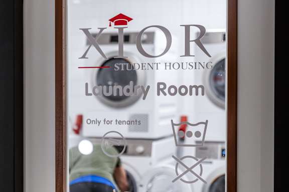 A window with a sign that says "Laundry Room Only for Tenants".