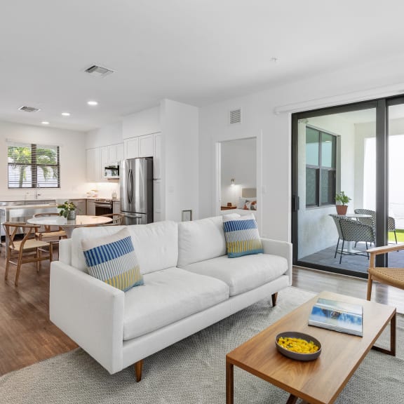 a living room with a white couch and a coffee table at Odyssey, Fort Myers, Florida